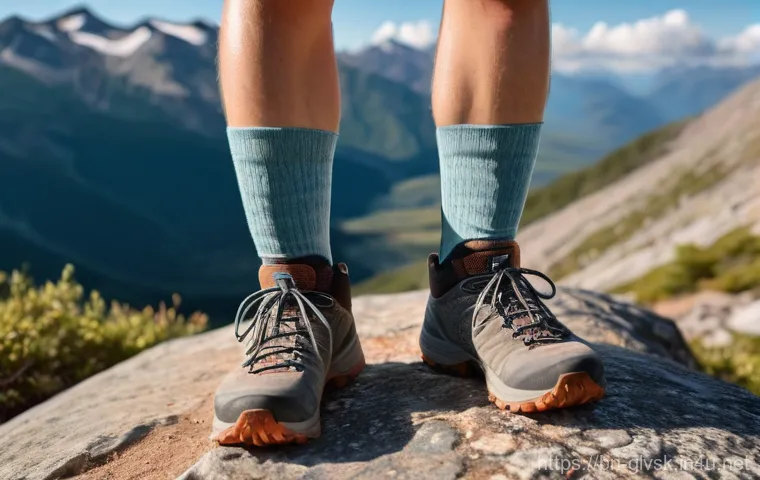 등산화와 궁합이 좋은 양말 - A close-up shot of a hiker's lower legs and feet on a picturesque mountain trail during daylight. On...